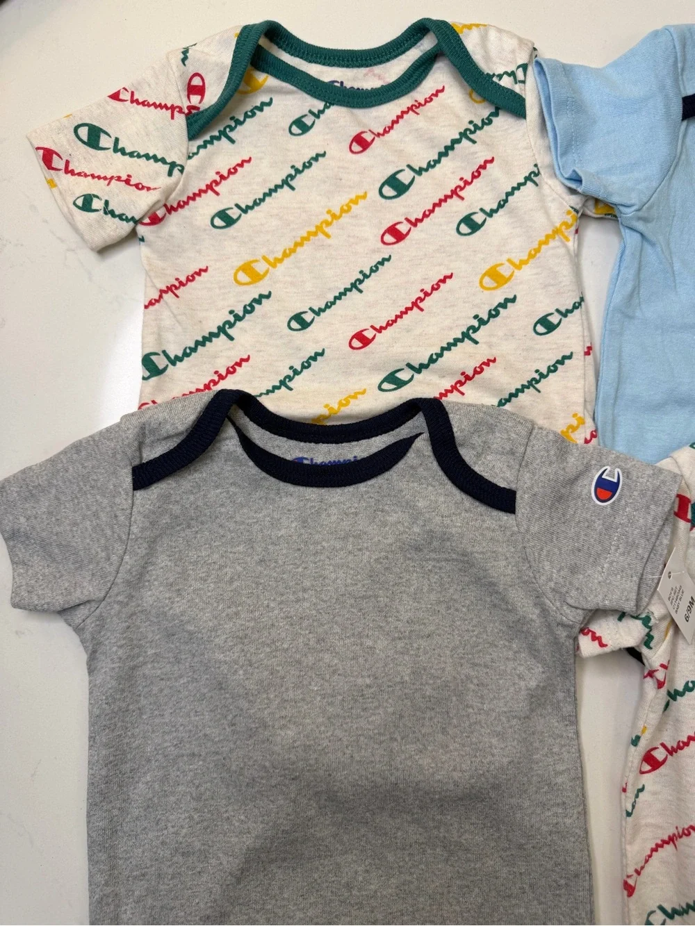 Champion 4-piece baby bodysuit bundle in size 6-9 months/9 months